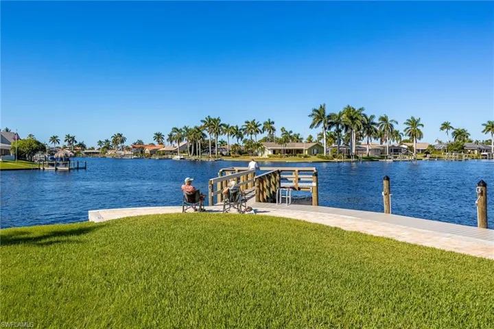 Dock featuring a residential view, a yard, and a water view