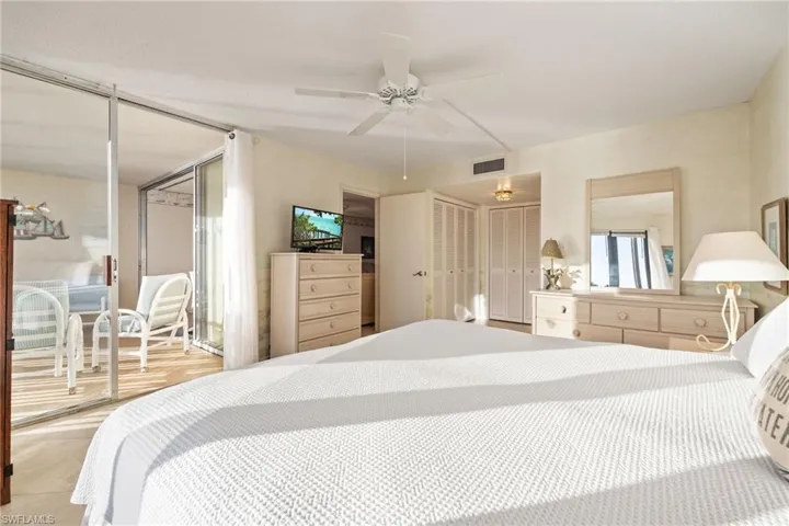 Bedroom with multiple closets and a ceiling fan