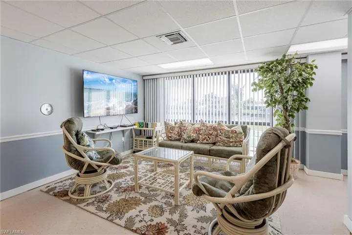 Living area with plenty of natural light and a paneled ceiling