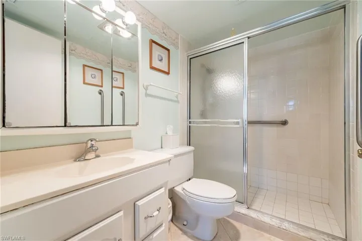 Bathroom featuring vanity, a stall shower, and light tile patterned flooring
