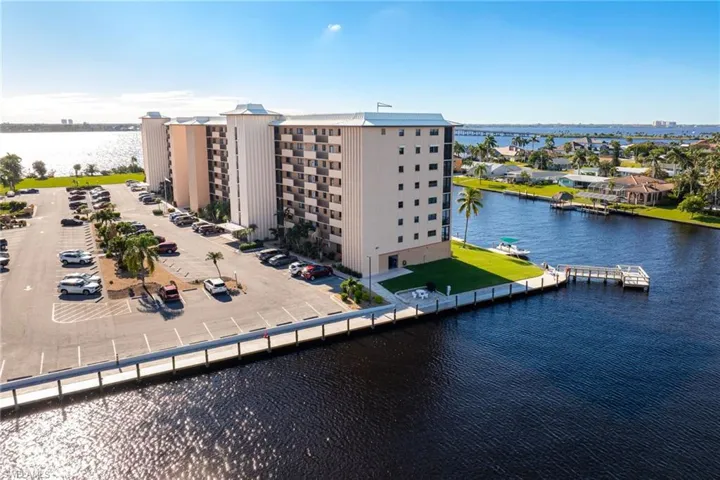 Aerial view of a nearby body of water and apartment complex / building