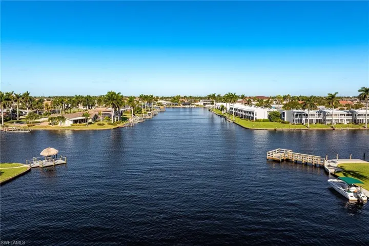 Water view with nearby suburban area and a floating dock