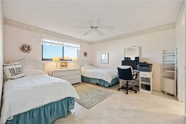 Bedroom with ceiling fan and a desk