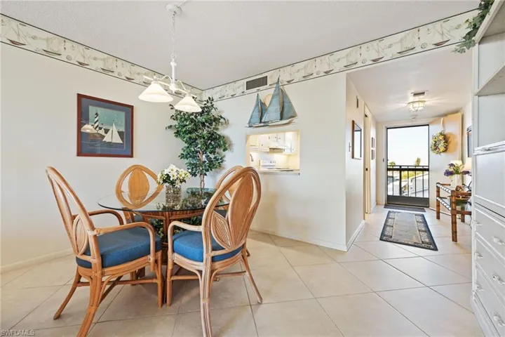 Dining area with light tile patterned floors and baseboards