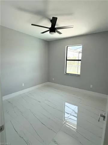 Spare room with ceiling fan and a textured ceiling