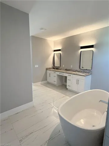 Bathroom with vanity and a tub to relax in