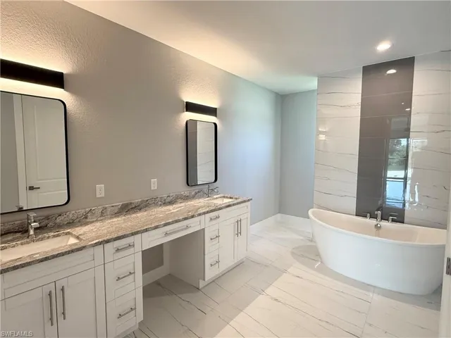 Bathroom featuring vanity and a tub