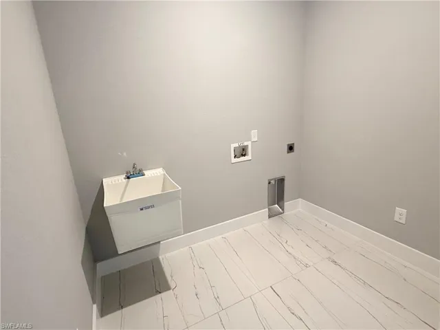 Clothes washing area with washer hookup, hookup for an electric dryer, and sink