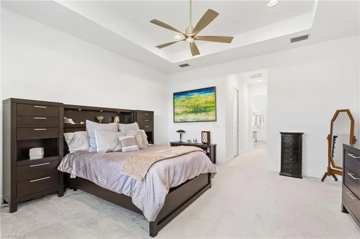 Primary bedroom with coffered ceiling, with 2 walk-in closets, ensuite spa-like bathroom.