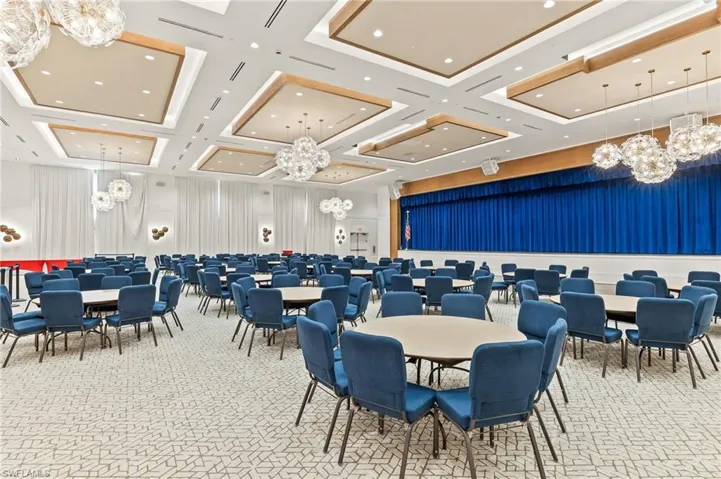 Ballroom with bar and stage for entertainment.