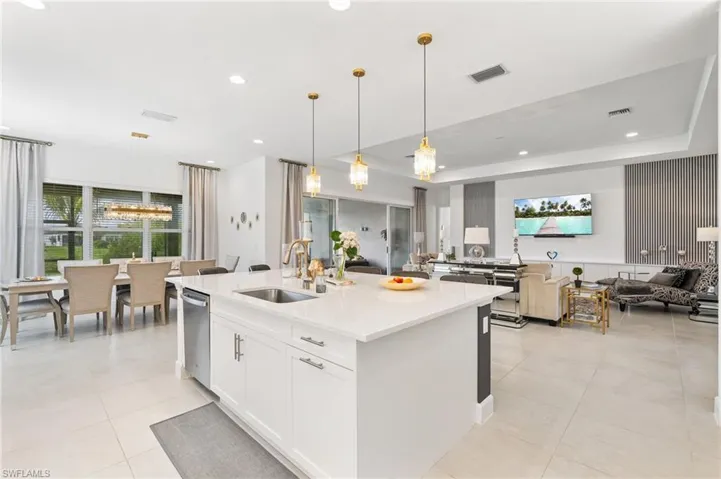 Kitchen island that seats six, pendant lights.