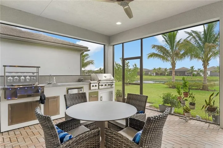 Outdoor living space with seating, and outdoor kitchen.