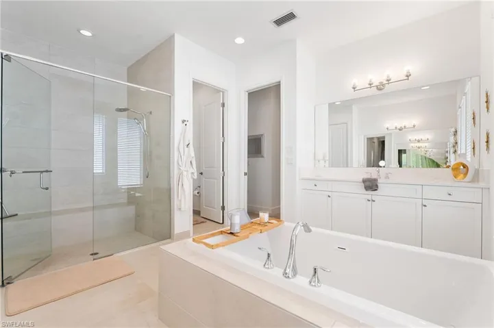 Walk in shower with tile-to-ceiling.