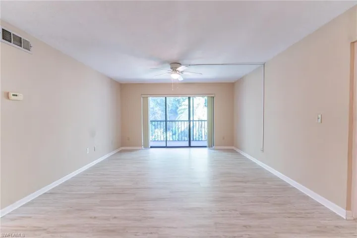 Empty room featuring ceiling fan and light wood-type flooring