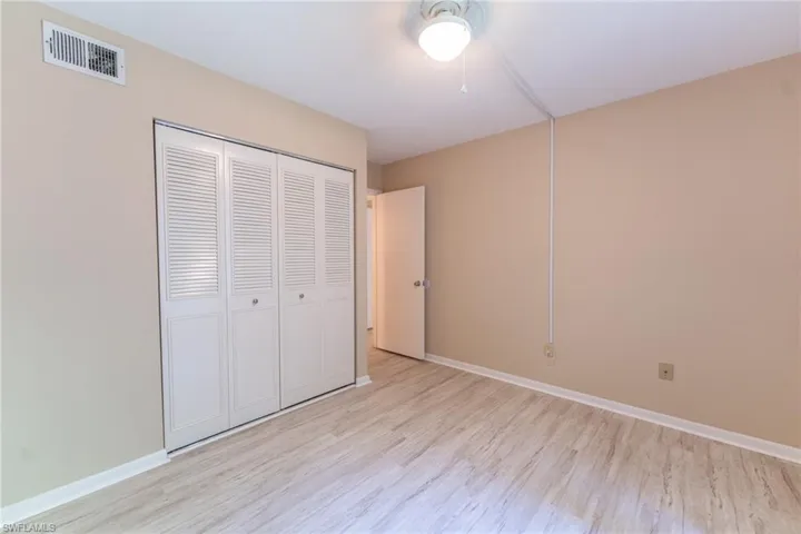 Unfurnished bedroom with a closet and light hardwood / wood-style flooring