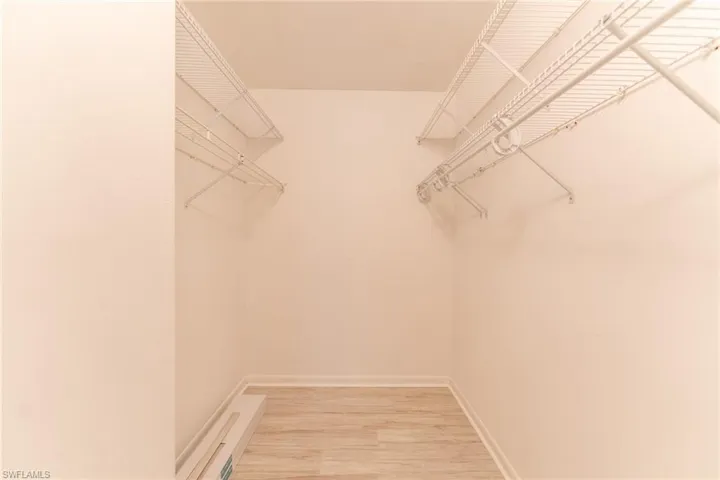 Spacious closet featuring hardwood / wood-style flooring