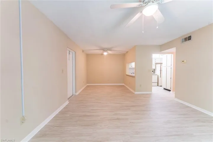 Empty room with ceiling fan and light hardwood / wood-style flooring