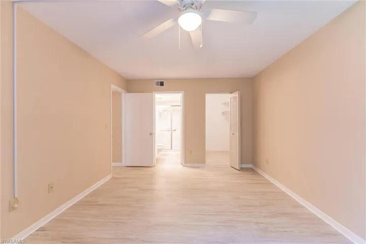Unfurnished bedroom featuring light hardwood / wood-style floors, a closet, and ceiling fan