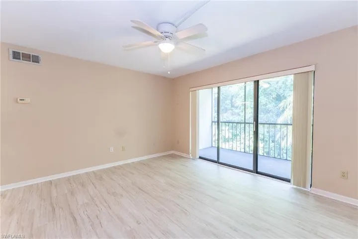 Empty room with light hardwood / wood-style floors and ceiling fan