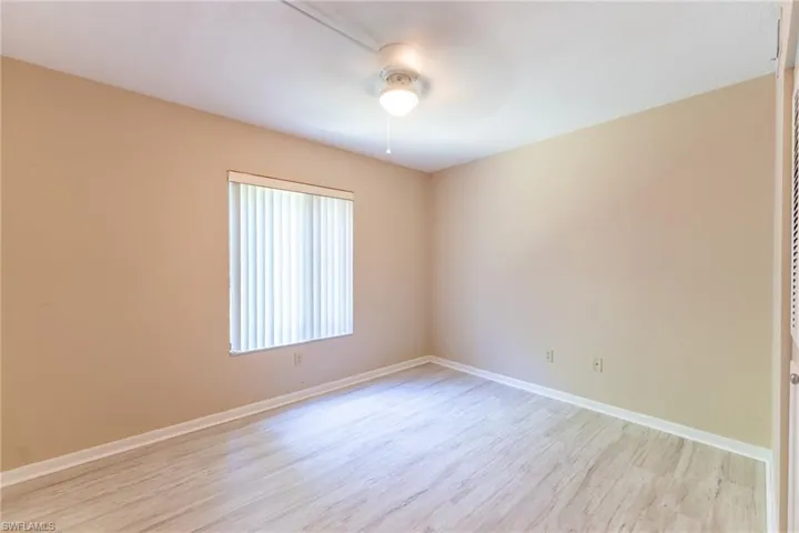 Unfurnished room featuring light wood-type flooring and ceiling fan