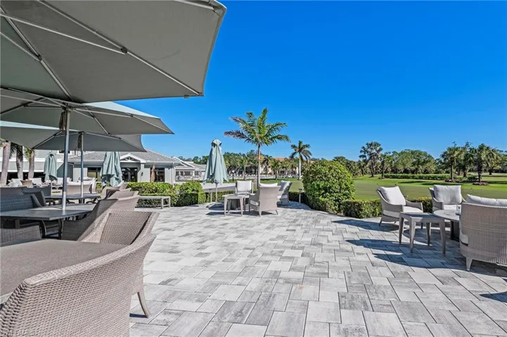 Expansive outdoor patio with paver flooring and manicured landscaping