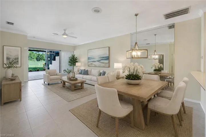 Open-concept living and dining area with tile flooring, a ceiling fan, and sliding glass doors opening to an outdoor patio