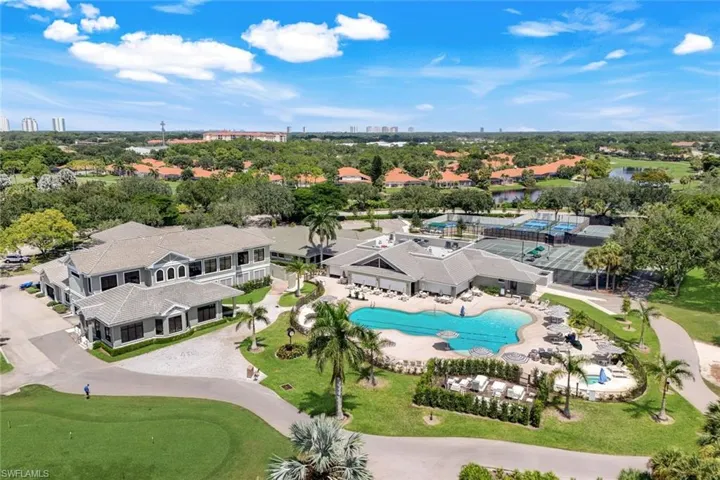 Expansive property featuring a large swimming pool, multiple tennis courts, and a golf course with lush landscaping