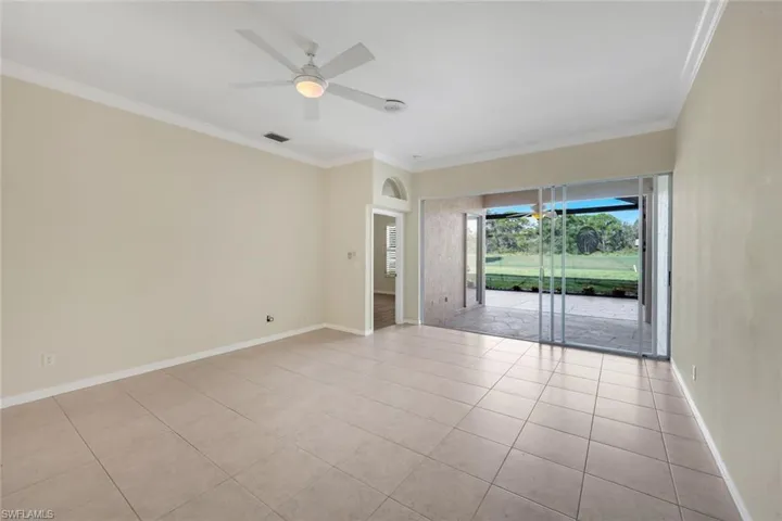 Neutral tone walls with crown molding, tile flooring, and a ceiling fan with integrated lighting
