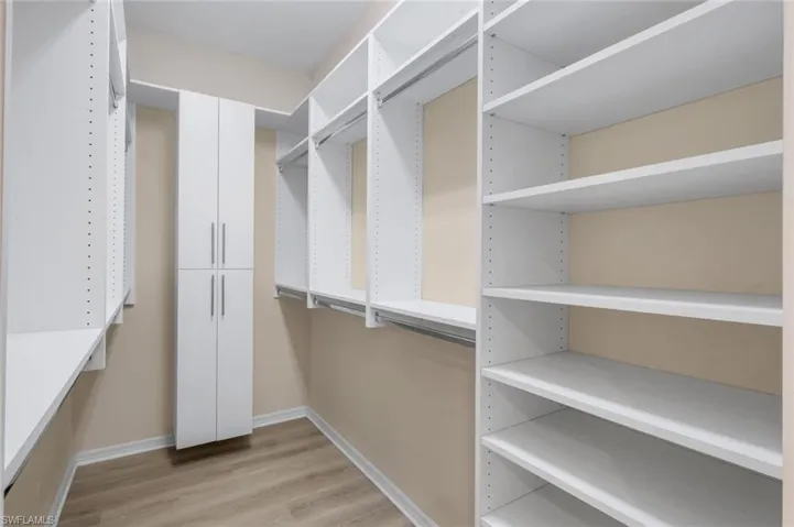 Custom closet system featuring extensive shelving and hanging rods