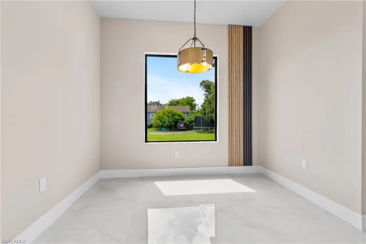 Unfurnished room with light marble finish flooring and baseboards