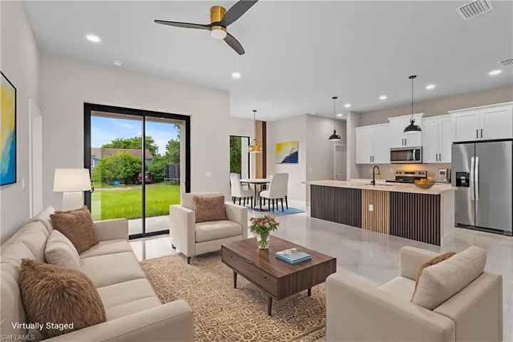 Living room featuring recessed lighting and a ceiling fan