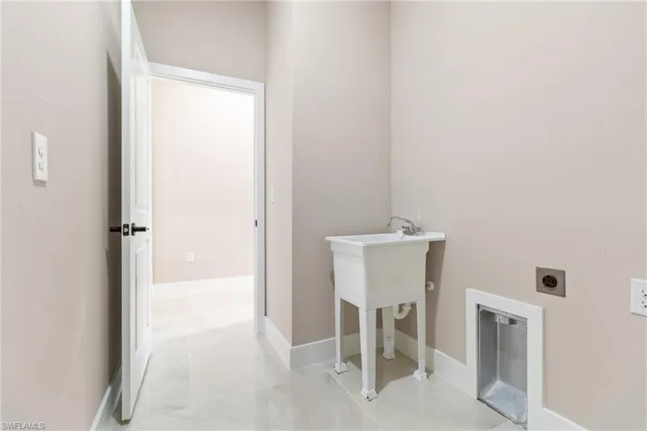 Laundry room featuring hookup for an electric dryer and baseboards