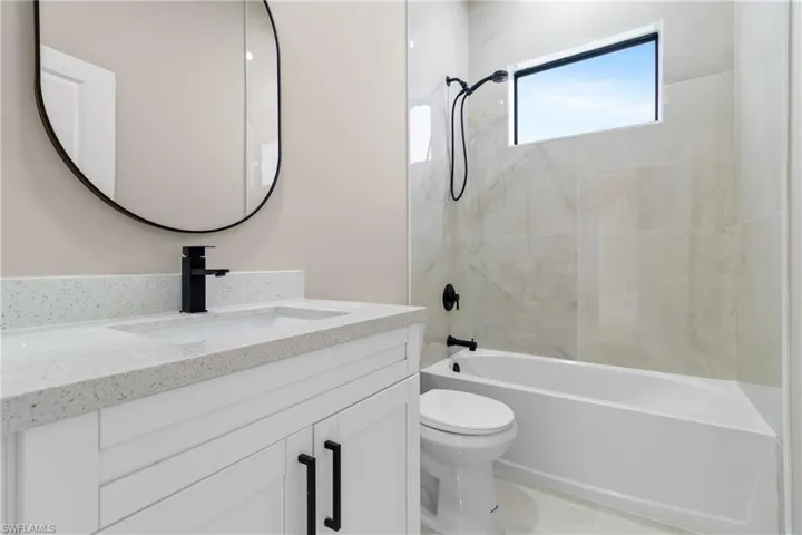 Bathroom featuring shower / bath combination and vanity