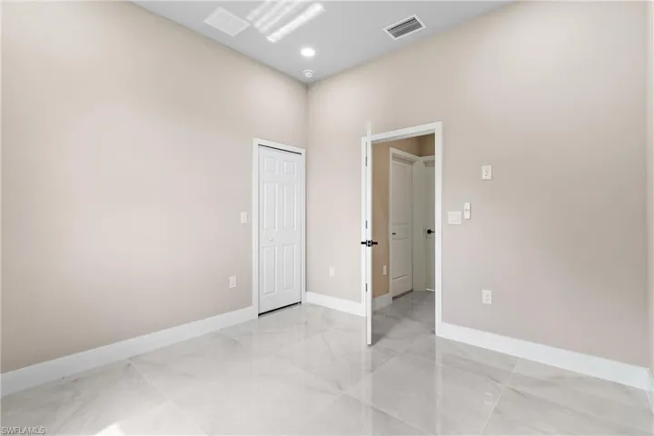 Empty room featuring baseboards and light marble finish floors