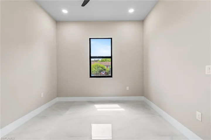 Spare room with a ceiling fan, recessed lighting, and light marble finish flooring