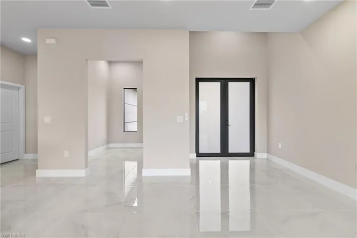 Spare room with recessed lighting and french doors