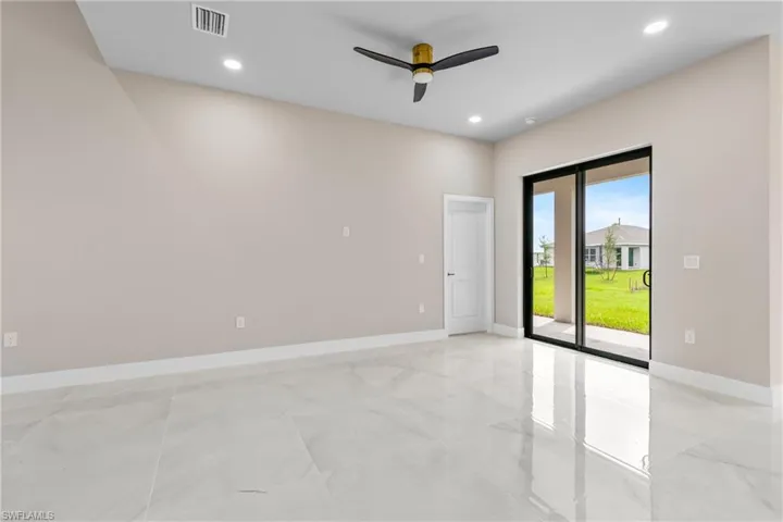 Empty room with a ceiling fan and recessed lighting