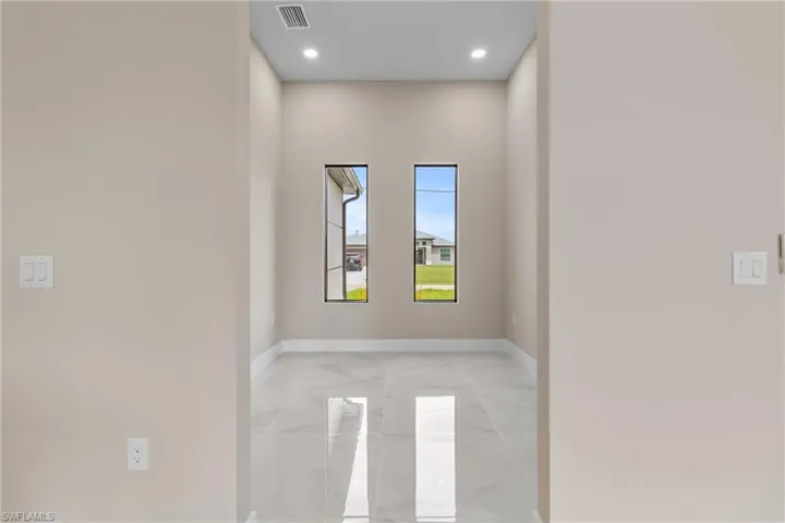 Empty room with baseboards and recessed lighting