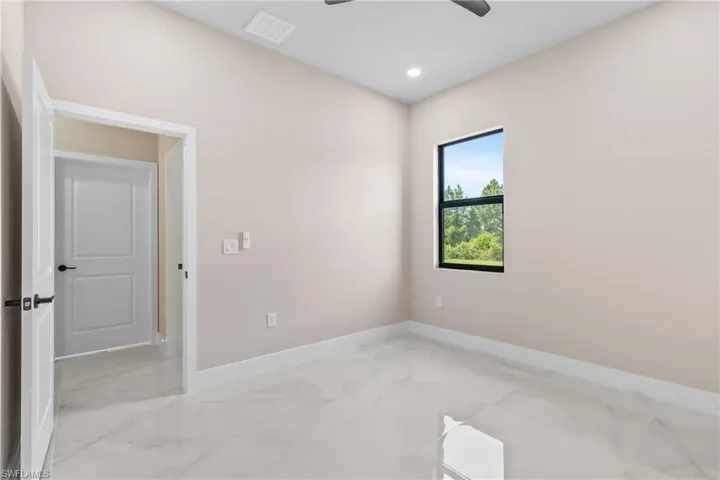 Unfurnished room with light marble finish flooring, a ceiling fan, and recessed lighting