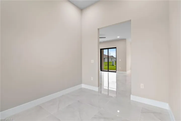 Empty room with light marble finish flooring and recessed lighting