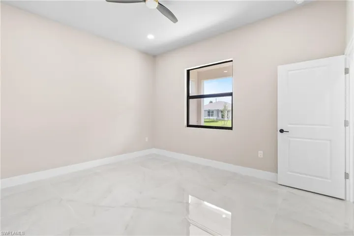 Spare room featuring light marble finish flooring, recessed lighting, and a ceiling fan