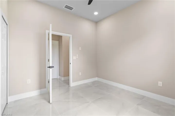 Unfurnished bedroom featuring baseboards and ceiling fan