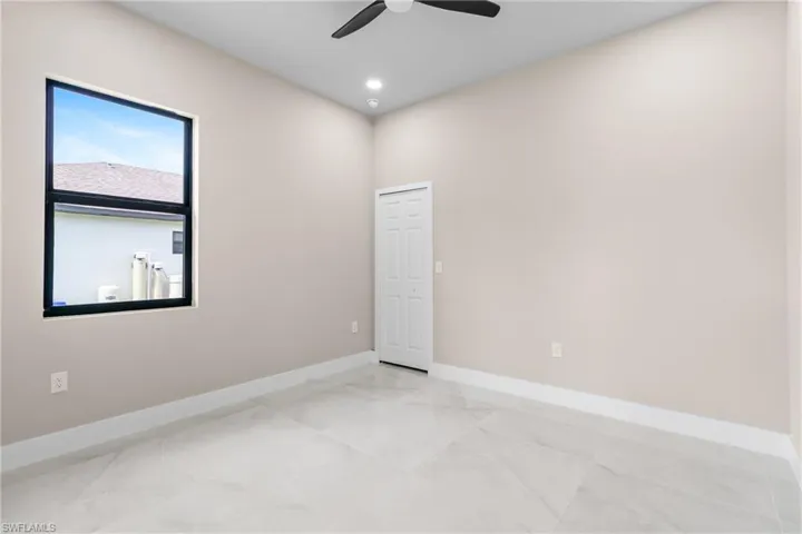 Spare room with recessed lighting, a ceiling fan, and light marble finish floors