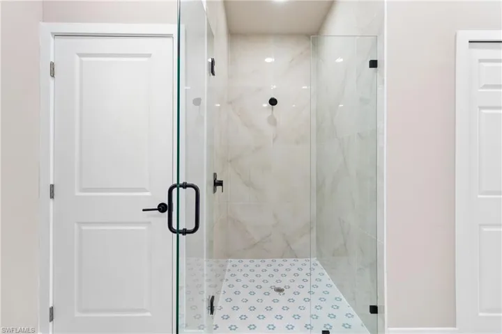 Bathroom featuring a marble finish shower