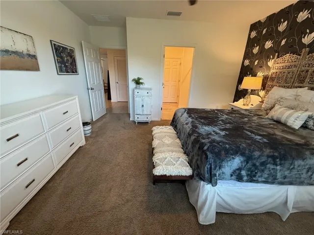 Bedroom with dark colored carpet