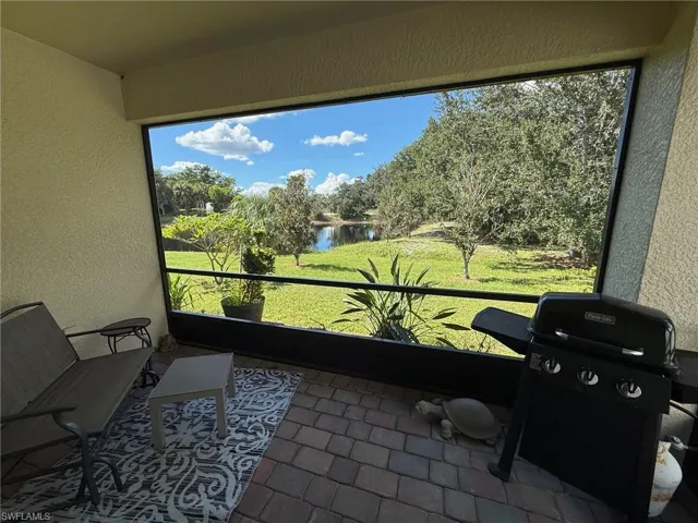 Sunroom / solarium featuring a water view