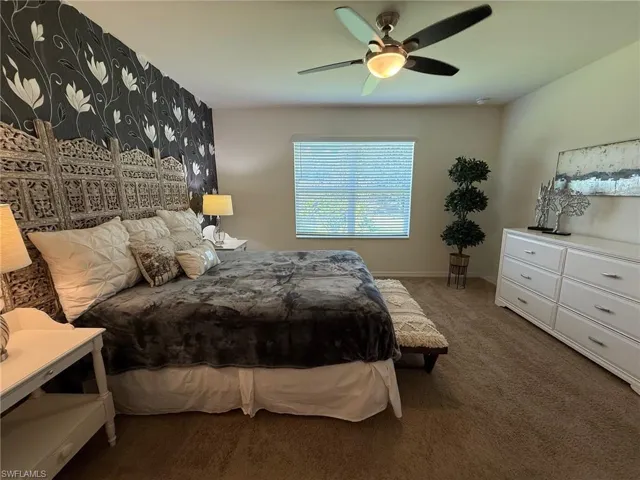Bedroom featuring carpet and ceiling fan