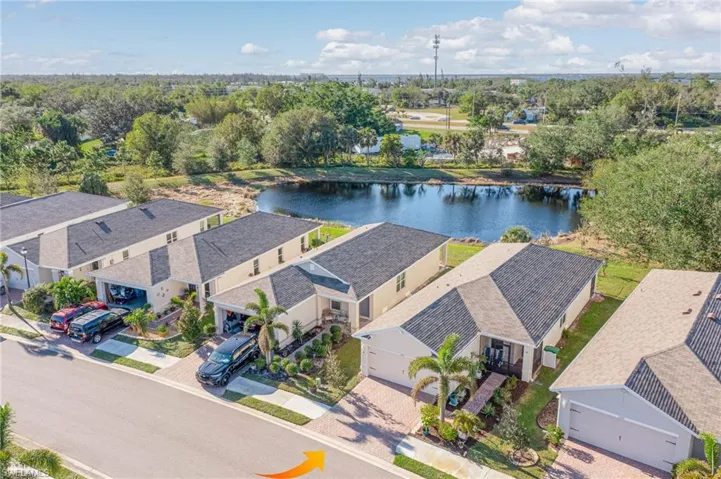 Aerial view of residential area featuring a nearby body of water