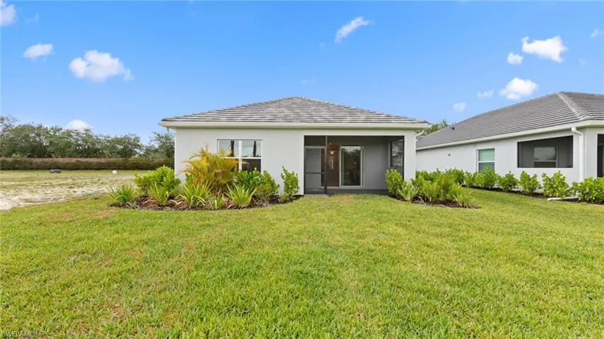 The backyard is pool-ready with a pool pre-wire package and ample room for a custom pool, set against a private preserve backdrop and manicured landscaping.