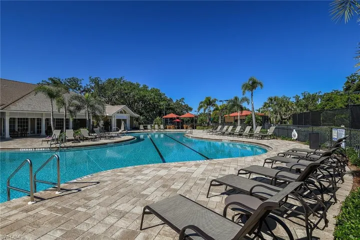 Lap lanes, a paver sundeck, and rows of loungers invite resort-style relaxation at the community pool.